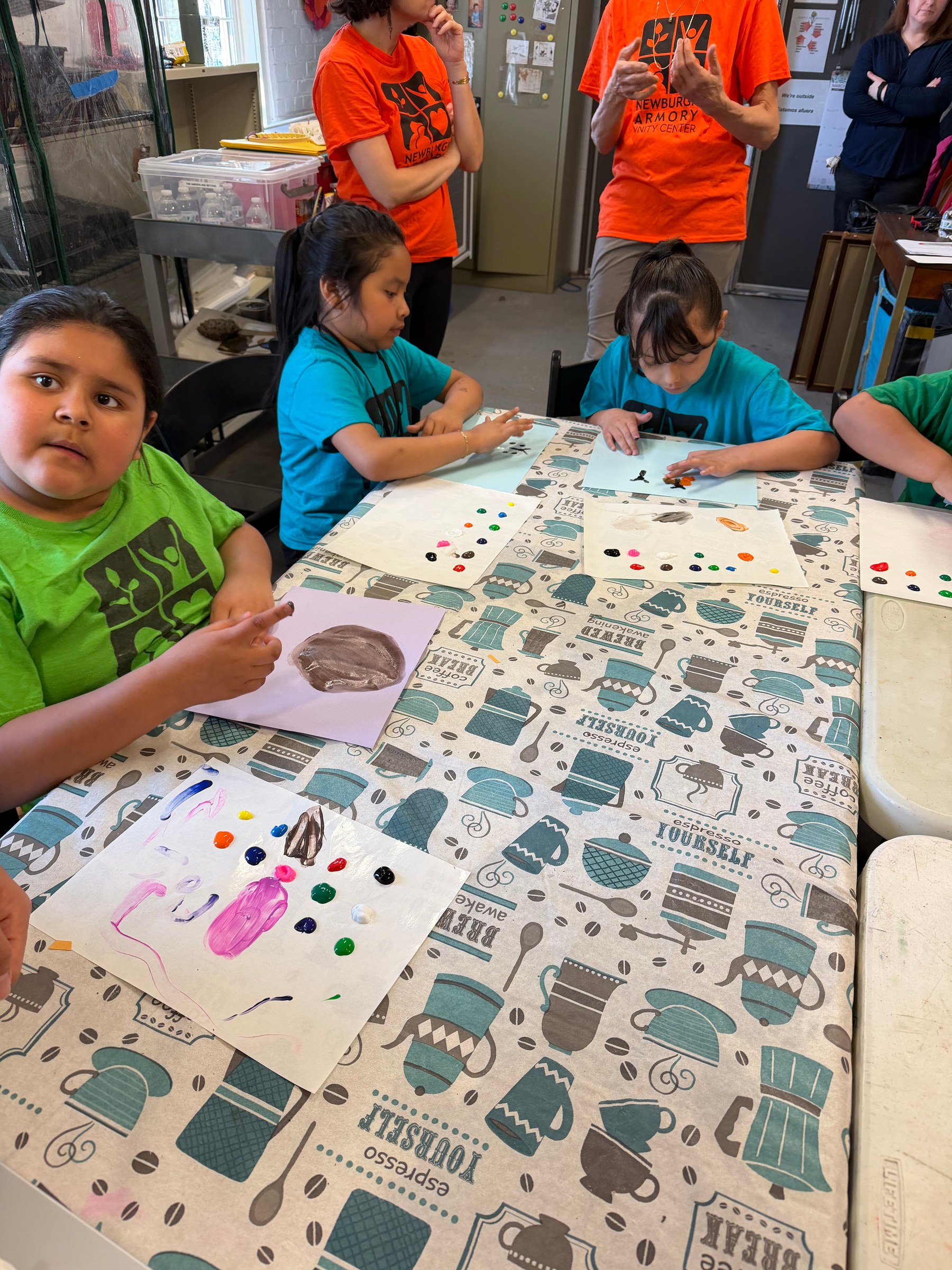 Children finger-painting animals and habitats