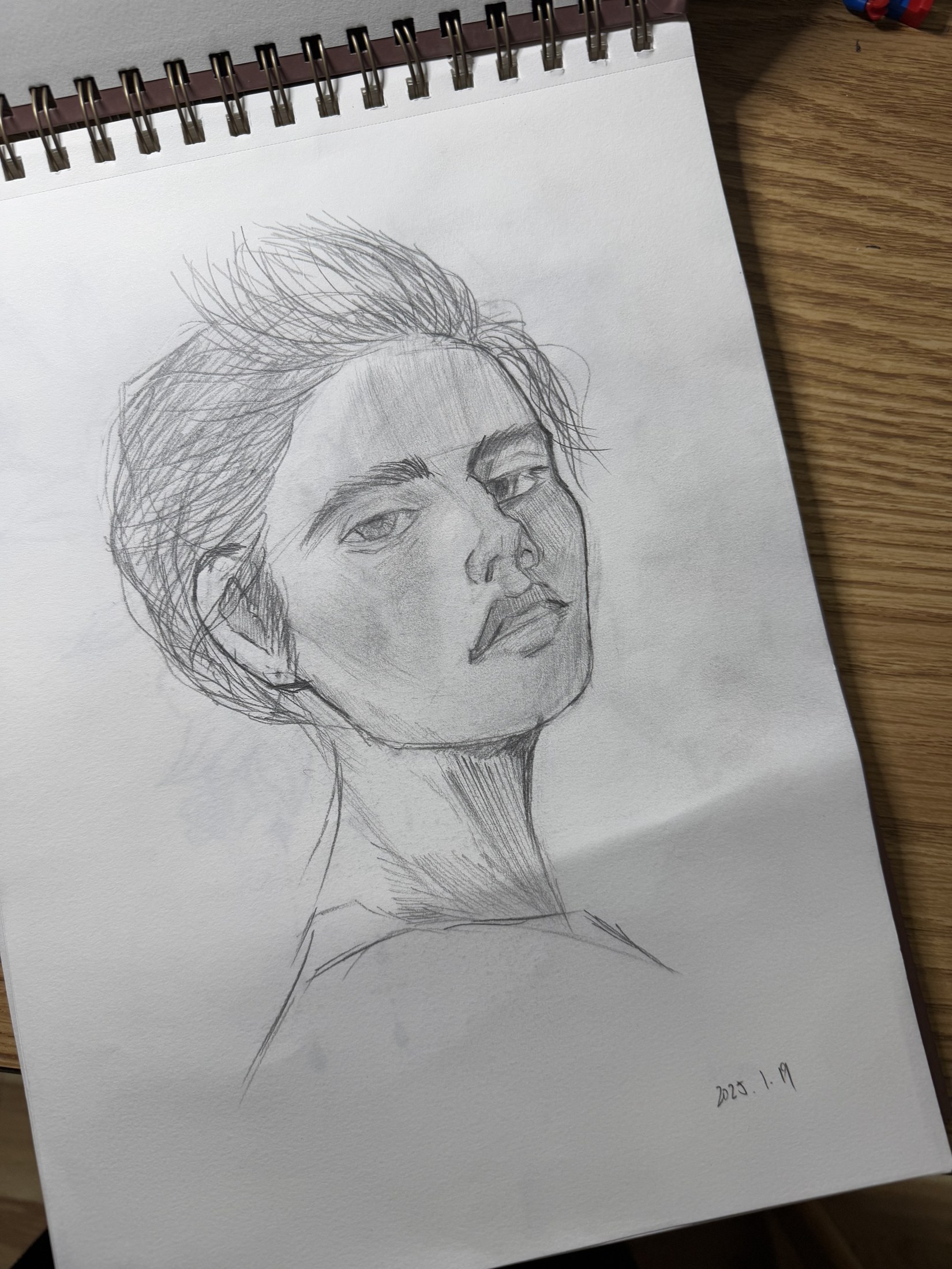 A pencil portrait in a sketchbook