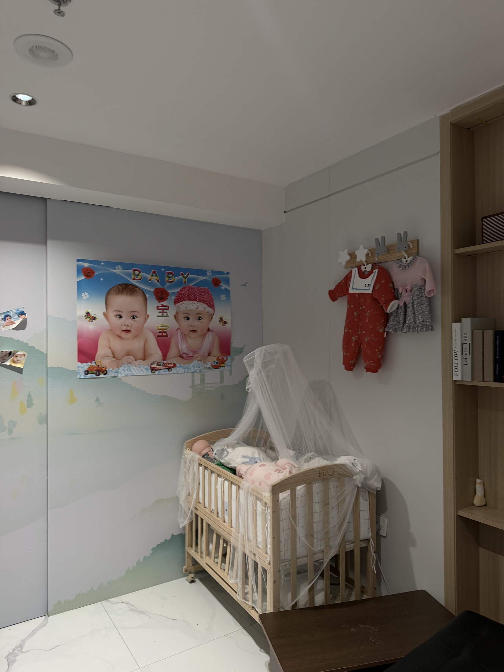 A crib and baby-themed decorations in the baby corner