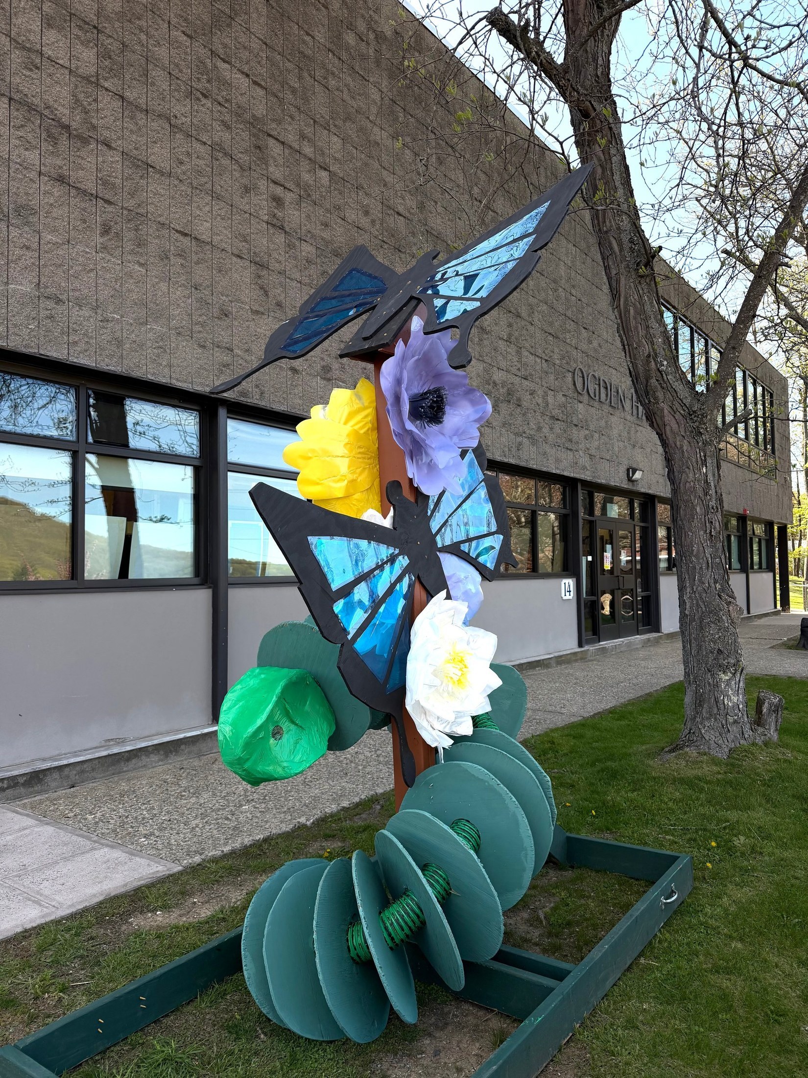 Spring installation displayed beside a school building